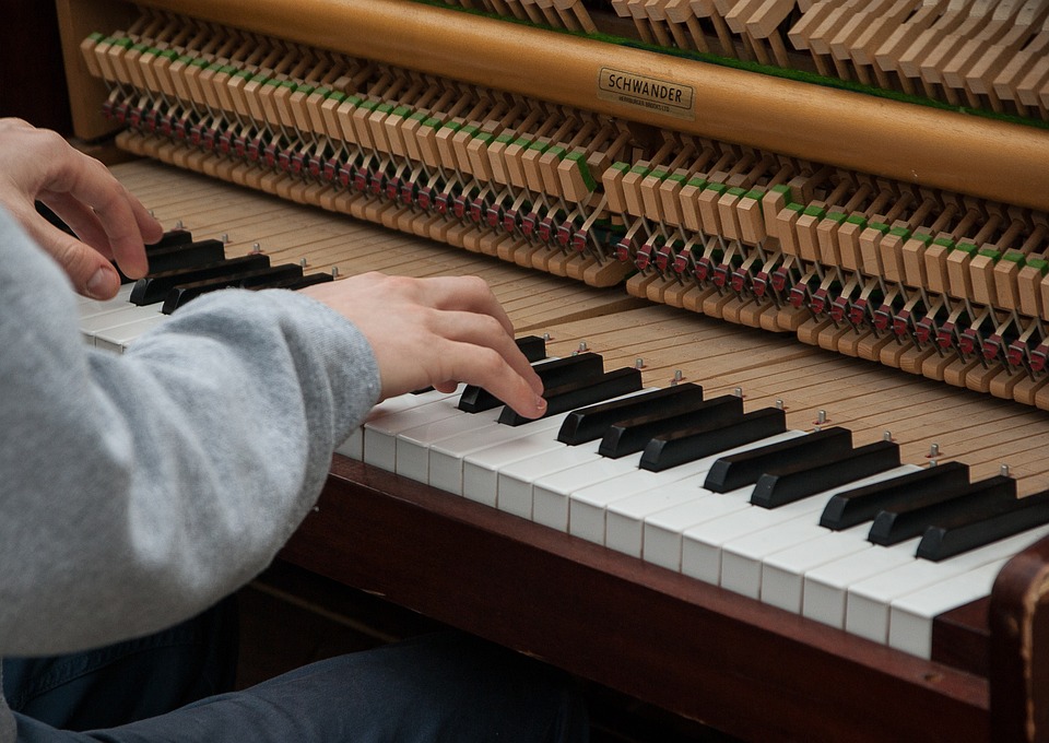 upright piano being played after a tuning